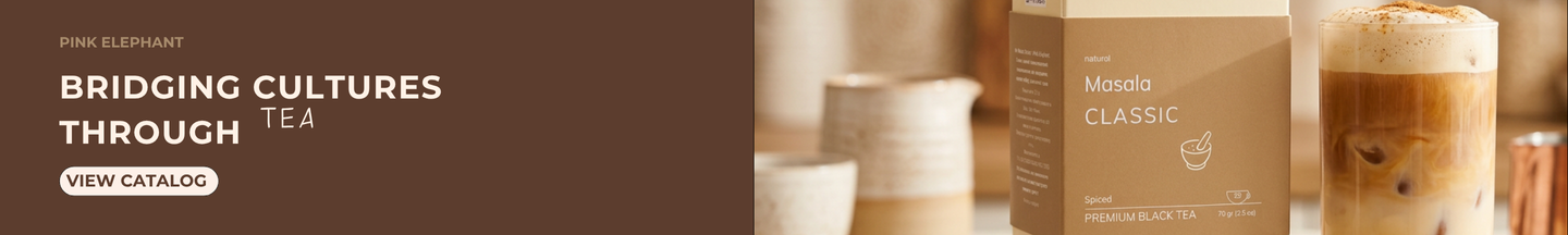 Pink Elephant hero banner: Masala Classic black tea box on a wooden surface next to ceramic pottery and iced tea with cinnamon, headline "Tea that builds a bridge between cultures"